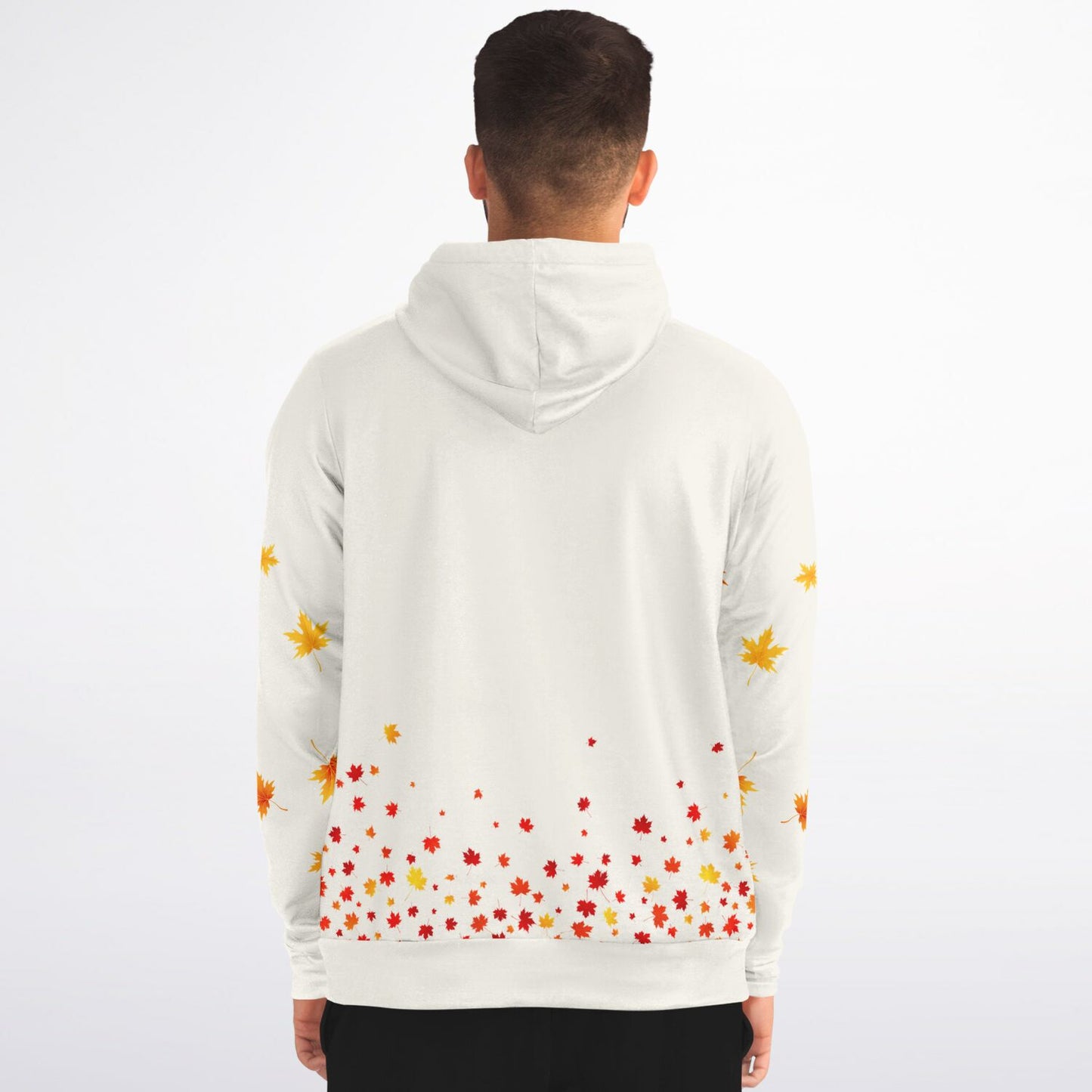A man viewed from behind wearing a white hoodie with a scattered autumn leaf print in red, orange, and yellow on the back and sleeves, set against a plain white background.