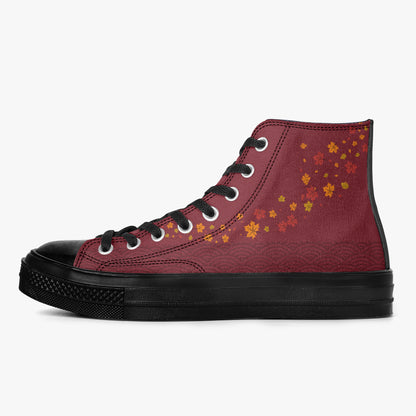 A high-top canvas sneaker in burgundy with a subtle wave pattern, decorated with small orange and yellow maple leaves on the side. It features black laces, a black rubber toe cap, and a thick black sole, shown against a plain light gray background.