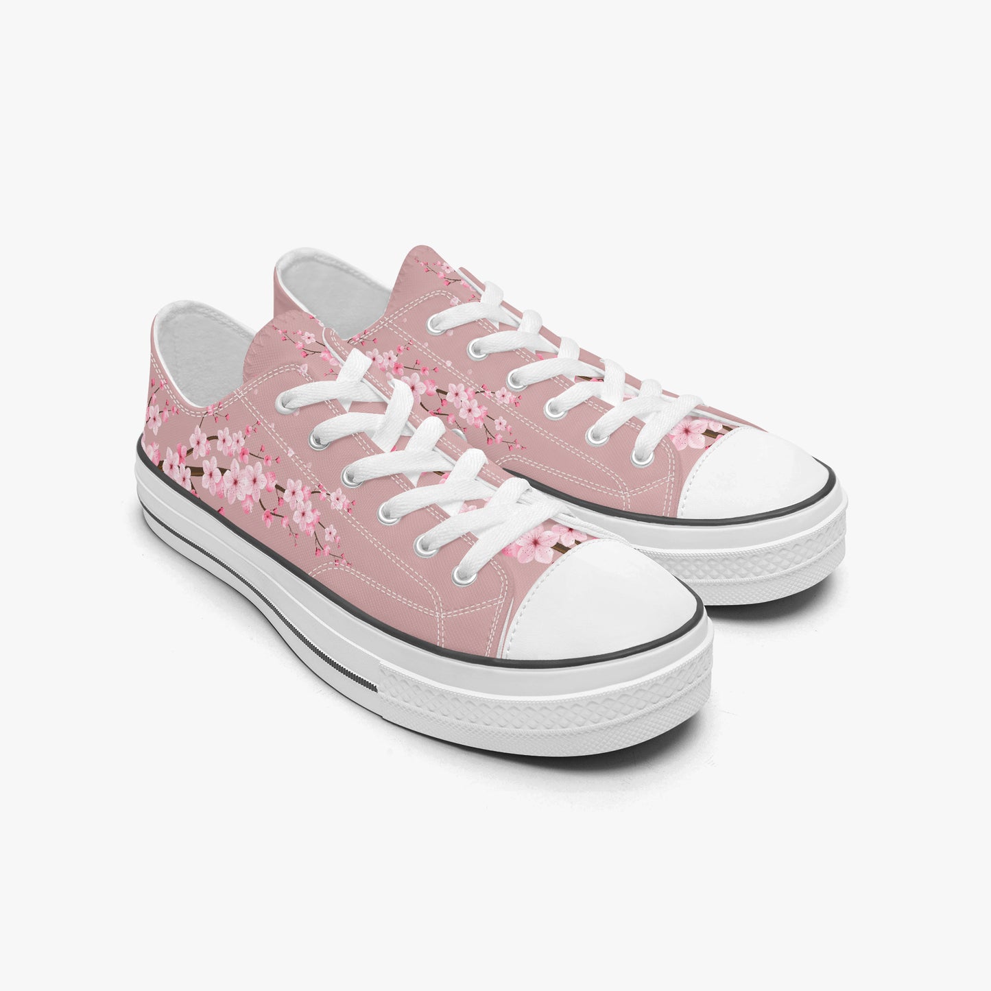Pink sneakers with white floral patterns on a white background