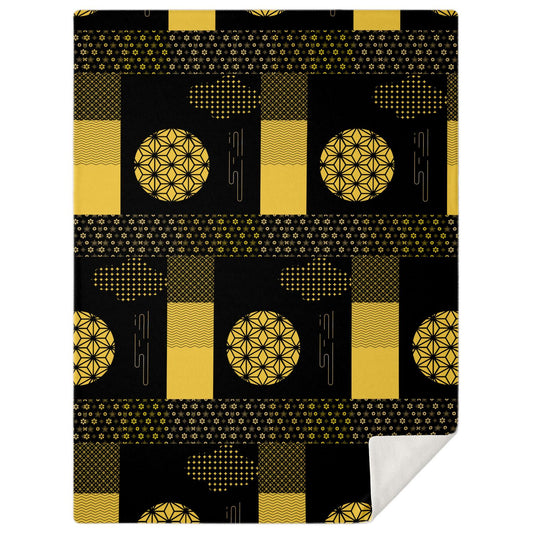 A high-angle, square photograph of a minimalist executive office featuring a desk and chair made of dark walnut wood. Draped over the chair is the Black and Gold Zen Layer Blanket from Kaito Japan Design. The blanket features a striking, high-contrast patchwork of deep iron-black and shimmering gold traditional Wagara motifs. Natural morning light streams through the window, emphasizing the luxurious metallic gold accents and creating an atmosphere of ultimate professional focus.