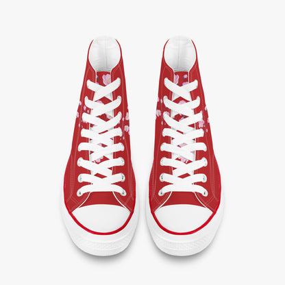 Red high-top sneakers with white laces on a white background