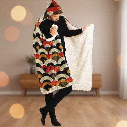 Person wearing a colorful patterned blanket with a hood on a white background