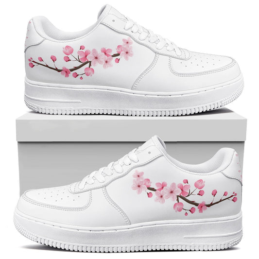 White sneakers with cherry blossom design on a white background