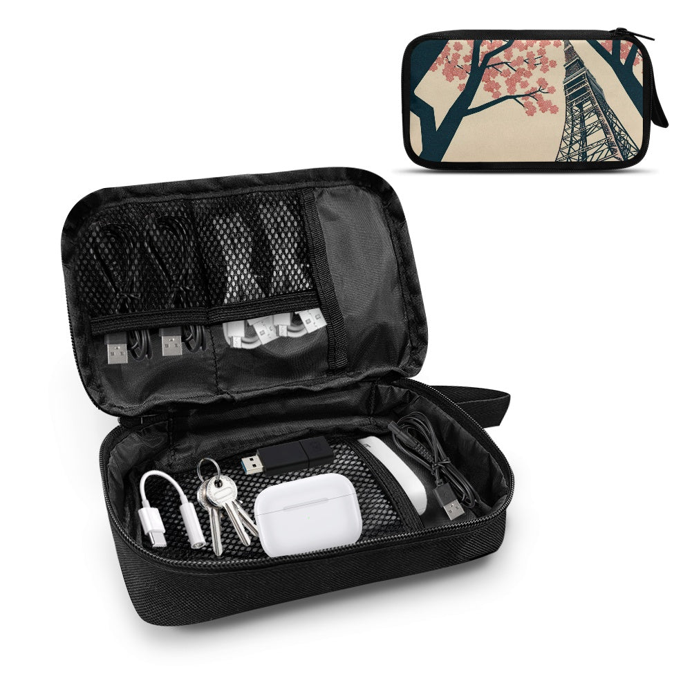 Black travel organization bag with various items and a smaller bag with Tokyo Tower design.