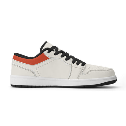 White sneaker with black and orange accents on a white background