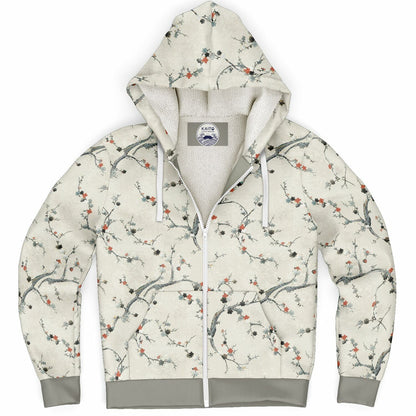 A zip-up hoodie with a beige and white floral branch pattern, featuring a white fleece lining, white drawstrings, and gray ribbed cuffs and hem.