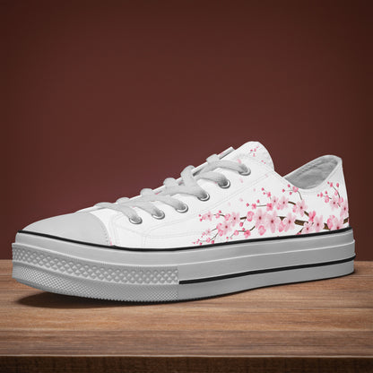 White sneaker with pink floral design on a wooden surface and brown background