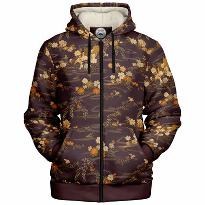 A dark brown zip-up hoodie with an all-over vintage-style floral and landscape print in beige, orange, and white, featuring a cream-colored hood lining and black drawstrings.