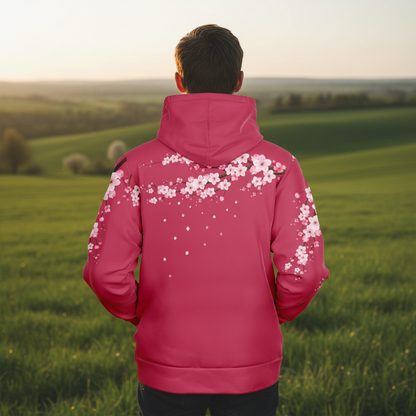 Man wearing a crimson hoodie with floral designs in an urban setting