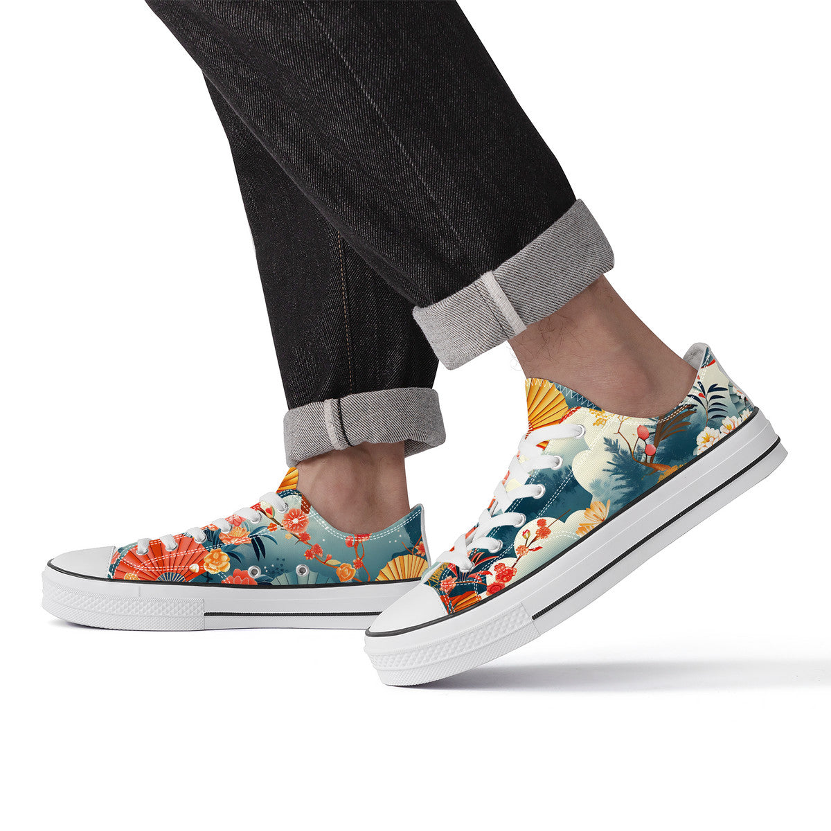 Colorful floral sneakers worn with rolled-up jeans on a white background