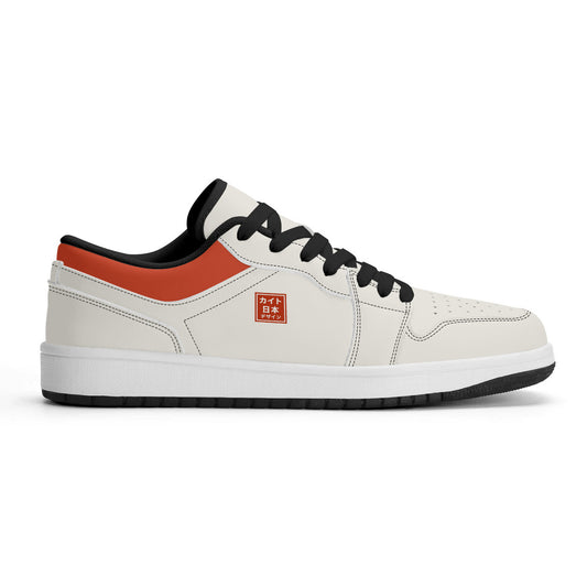 White sneaker with black and orange accents on a white background