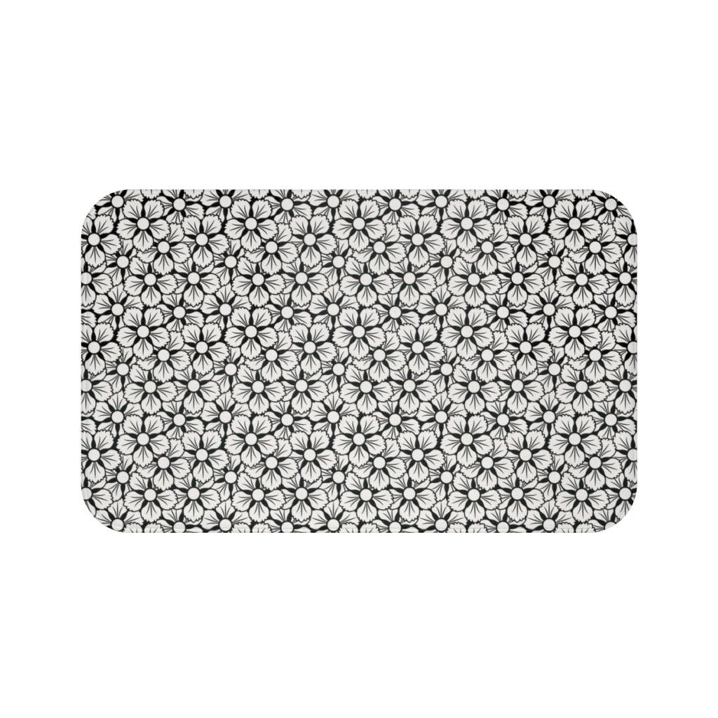 White and Black Flower Japanese Pattern Bath Mat.   Japanese style bathmats are the perfect finishing flourish for a stylish, personality-filled bathroom, and this bath mat is as practical, as it is stylish - the anti-slip backing keeps the bath mat firmly in place and reduces the risk of slipping. 100% Microfiber. Vibrant print exit in 2 sizes 34” x 21” (86 x 53 cm) or 24” x 17” (61 x 43 cm). Anti-slip backing. Binding around the edges. Machine wash cold, gentle cycle. Tumble dry low or line dry. 