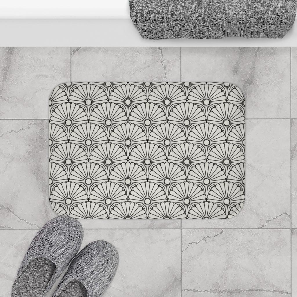 Large White Flower on Grey Japanese Pattern Bath Mat.   Japanese style bathmats are the perfect finishing flourish for a stylish, personality-filled bathroom, and this bath mat is as practical, as it is stylish - the anti-slip backing keeps the bath mat firmly in place and reduces the risk of slipping. 100% Microfiber. Vibrant print exit in 2 sizes 34” x 21” (86 x 53 cm) or 24” x 17” (61 x 43 cm). Anti-slip backing. Binding around the edges. Machine wash cold, gentle cycle. Tumble dry low or line dry. 