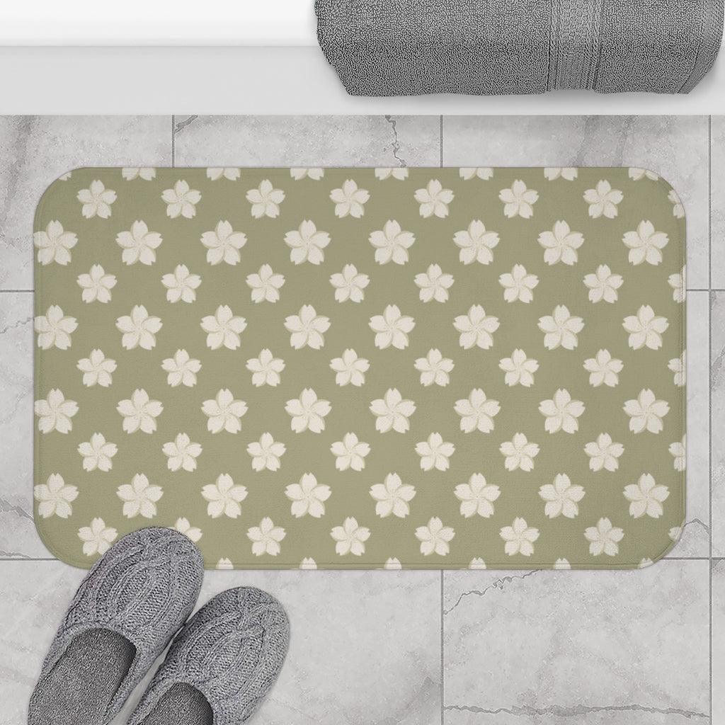White Flower on Brown Japanese Pattern Bath Mat.   Japanese style bathmats are the perfect finishing flourish for a stylish, personality-filled bathroom, and this bath mat is as practical, as it is stylish - the anti-slip backing keeps the bath mat firmly in place and reduces the risk of slipping. 100% Microfiber. Vibrant print exit in 2 sizes 34” x 21” (86 x 53 cm) or 24” x 17” (61 x 43 cm). Anti-slip backing. Binding around the edges. Machine wash cold, gentle cycle. Tumble dry low or line dry. 