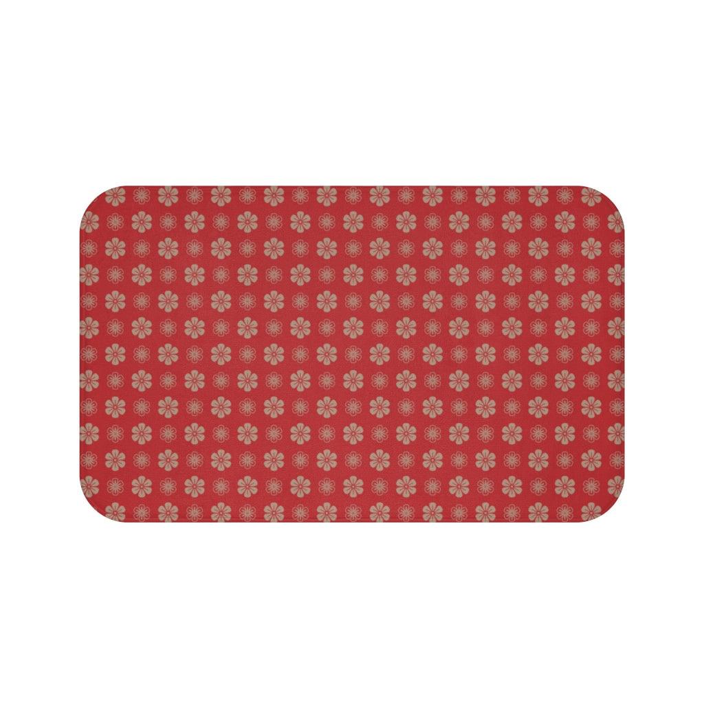 Dark Gold Flower on Red Background Bath Mat.   Japanese style bathmats are the perfect finishing flourish for a stylish, personality-filled bathroom, and this bath mat is as practical, as it is stylish - the anti-slip backing keeps the bath mat firmly in place and reduces the risk of slipping. 100% Microfiber. Vibrant print exit in 2 sizes 34” x 21” (86 x 53 cm) or 24” x 17” (61 x 43 cm). Anti-slip backing. Binding around the edges. Machine wash cold, gentle cycle. Tumble dry low or line dry. 
