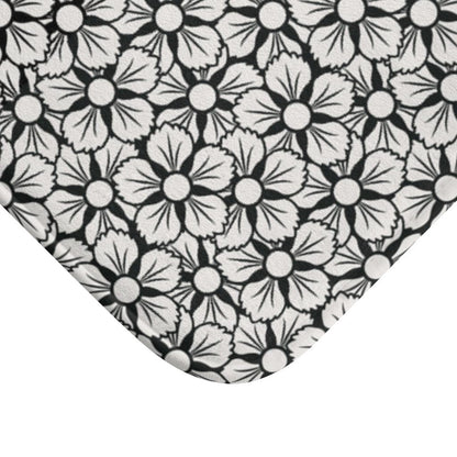 White and Black Flower Japanese Pattern Bath Mat.   Japanese style bathmats are the perfect finishing flourish for a stylish, personality-filled bathroom, and this bath mat is as practical, as it is stylish - the anti-slip backing keeps the bath mat firmly in place and reduces the risk of slipping. 100% Microfiber. Vibrant print exit in 2 sizes 34” x 21” (86 x 53 cm) or 24” x 17” (61 x 43 cm). Anti-slip backing. Binding around the edges. Machine wash cold, gentle cycle. Tumble dry low or line dry. 