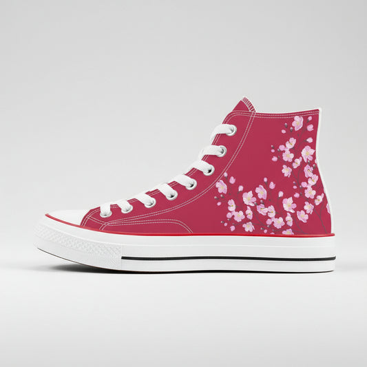 A pair of high-top canvas shoes featuring a cherry blossom design in pink on a white background.