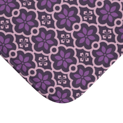Purple Flower and Pink Lines Japanese Pattern Bath Mat.   Japanese style bathmats are the perfect finishing flourish for a stylish, personality-filled bathroom, and this bath mat is as practical, as it is stylish - the anti-slip backing keeps the bath mat firmly in place and reduces the risk of slipping. 100% Microfiber. Vibrant print exit in 2 sizes 34” x 21” (86 x 53 cm) or 24” x 17” (61 x 43 cm). Anti-slip backing. Binding around the edges. Machine wash cold, gentle cycle. Tumble dry low or line dry. 