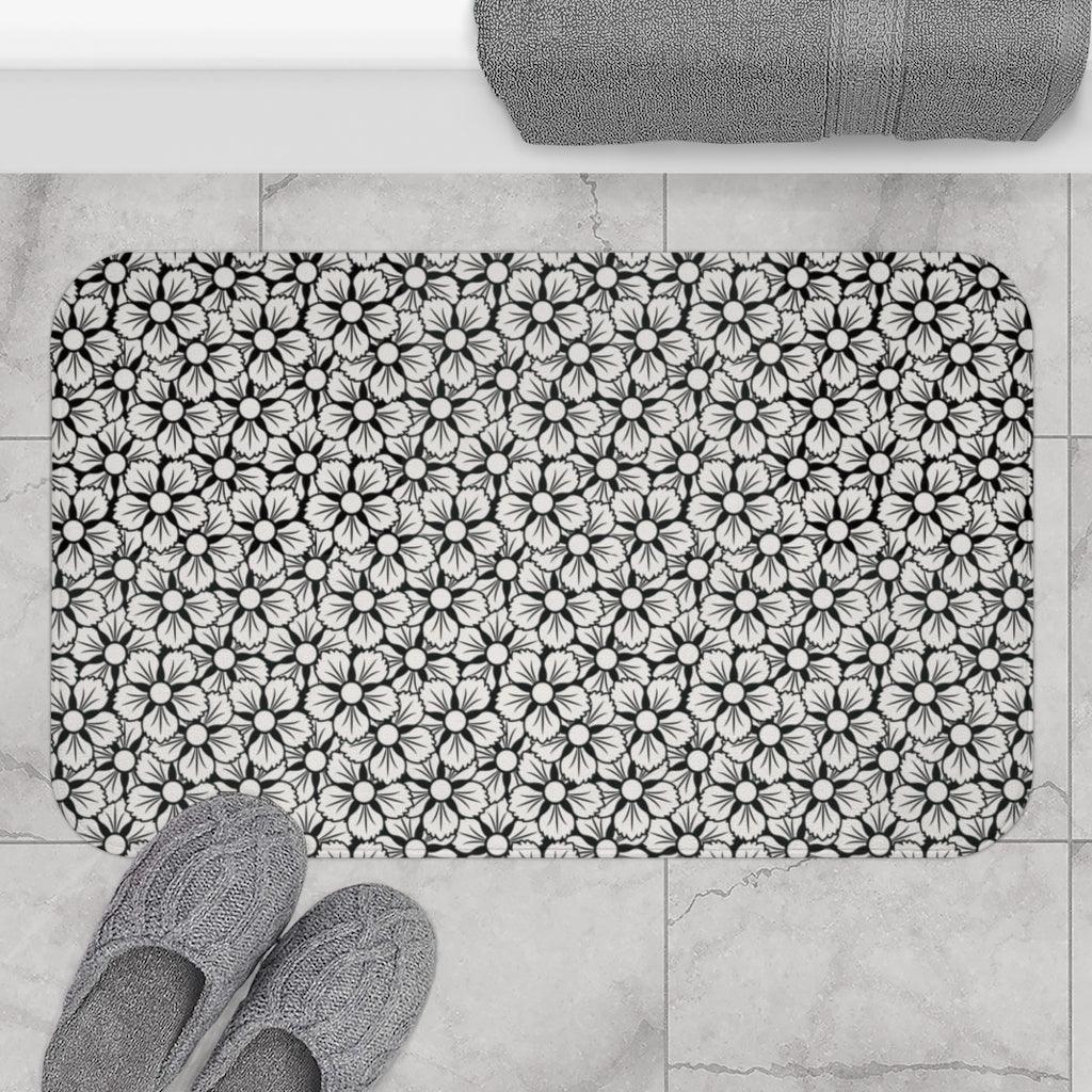 White and Black Flower Japanese Pattern Bath Mat.   Japanese style bathmats are the perfect finishing flourish for a stylish, personality-filled bathroom, and this bath mat is as practical, as it is stylish - the anti-slip backing keeps the bath mat firmly in place and reduces the risk of slipping. 100% Microfiber. Vibrant print exit in 2 sizes 34” x 21” (86 x 53 cm) or 24” x 17” (61 x 43 cm). Anti-slip backing. Binding around the edges. Machine wash cold, gentle cycle. Tumble dry low or line dry. 