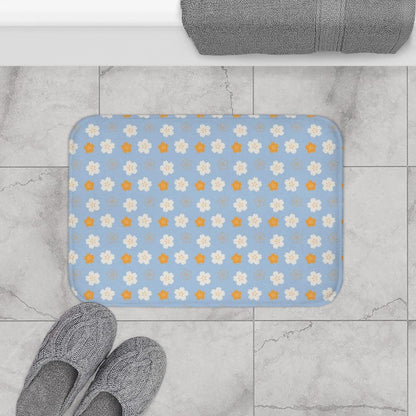 Orange and White Flower on Blue Origami Pattern Bath Mat.   Japanese style bathmats are the perfect finishing flourish for a stylish, personality-filled bathroom, and this bath mat is as practical, as it is stylish - the anti-slip backing keeps the bath mat firmly in place and reduces the risk of slipping. 100% Microfiber. Vibrant print exit in 2 sizes 34” x 21” (86 x 53 cm) or 24” x 17” (61 x 43 cm). Anti-slip backing. Binding around the edges. Machine wash cold, gentle cycle. Tumble dry low or line dry. 