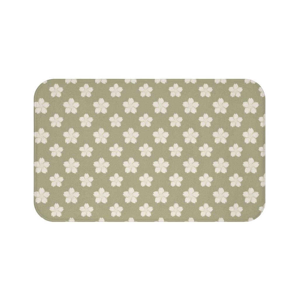 White Flower on Brown Japanese Pattern Bath Mat.   Japanese style bathmats are the perfect finishing flourish for a stylish, personality-filled bathroom, and this bath mat is as practical, as it is stylish - the anti-slip backing keeps the bath mat firmly in place and reduces the risk of slipping. 100% Microfiber. Vibrant print exit in 2 sizes 34” x 21” (86 x 53 cm) or 24” x 17” (61 x 43 cm). Anti-slip backing. Binding around the edges. Machine wash cold, gentle cycle. Tumble dry low or line dry. 