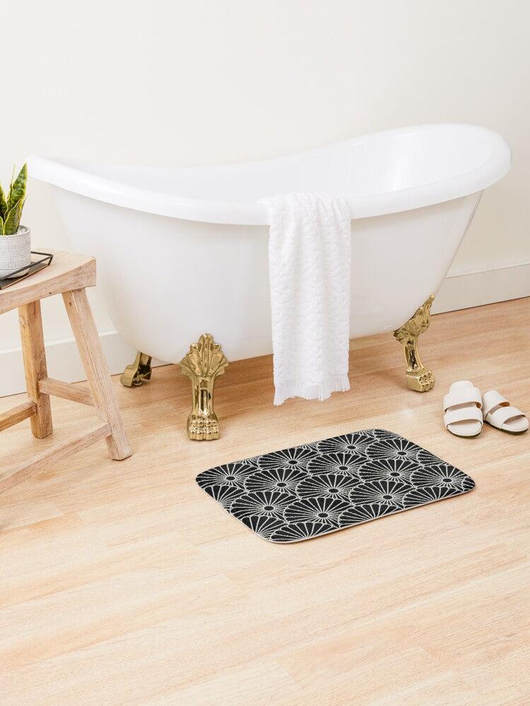 Large Black Japanese Flower on Grey Background Bath Mat.   Japanese style bathmats are the perfect finishing flourish for a stylish, personality-filled bathroom, and this bath mat is as practical, as it is stylish - the anti-slip backing keeps the bath mat firmly in place and reduces the risk of slipping. 100% Microfiber. Vibrant print exit in 2 sizes 34” x 21” (86 x 53 cm) or 24” x 17” (61 x 43 cm). Anti-slip backing. Binding around the edges. Machine wash cold, gentle cycle. Tumble dry low or line dry. 