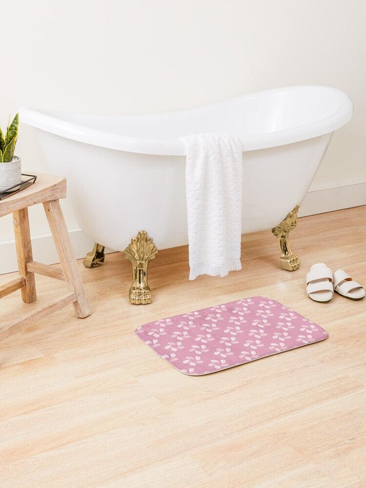 Shade of Pink Petal Flower Japanese Pattern Bath Mat.   Japanese style bathmats are the perfect finishing flourish for a stylish, personality-filled bathroom, and this bath mat is as practical, as it is stylish - the anti-slip backing keeps the bath mat firmly in place and reduces the risk of slipping. 100% Microfiber. Vibrant print exit in 2 sizes 34” x 21” (86 x 53 cm) or 24” x 17” (61 x 43 cm). Anti-slip backing. Binding around the edges. Machine wash cold, gentle cycle. Tumble dry low or line dry. 